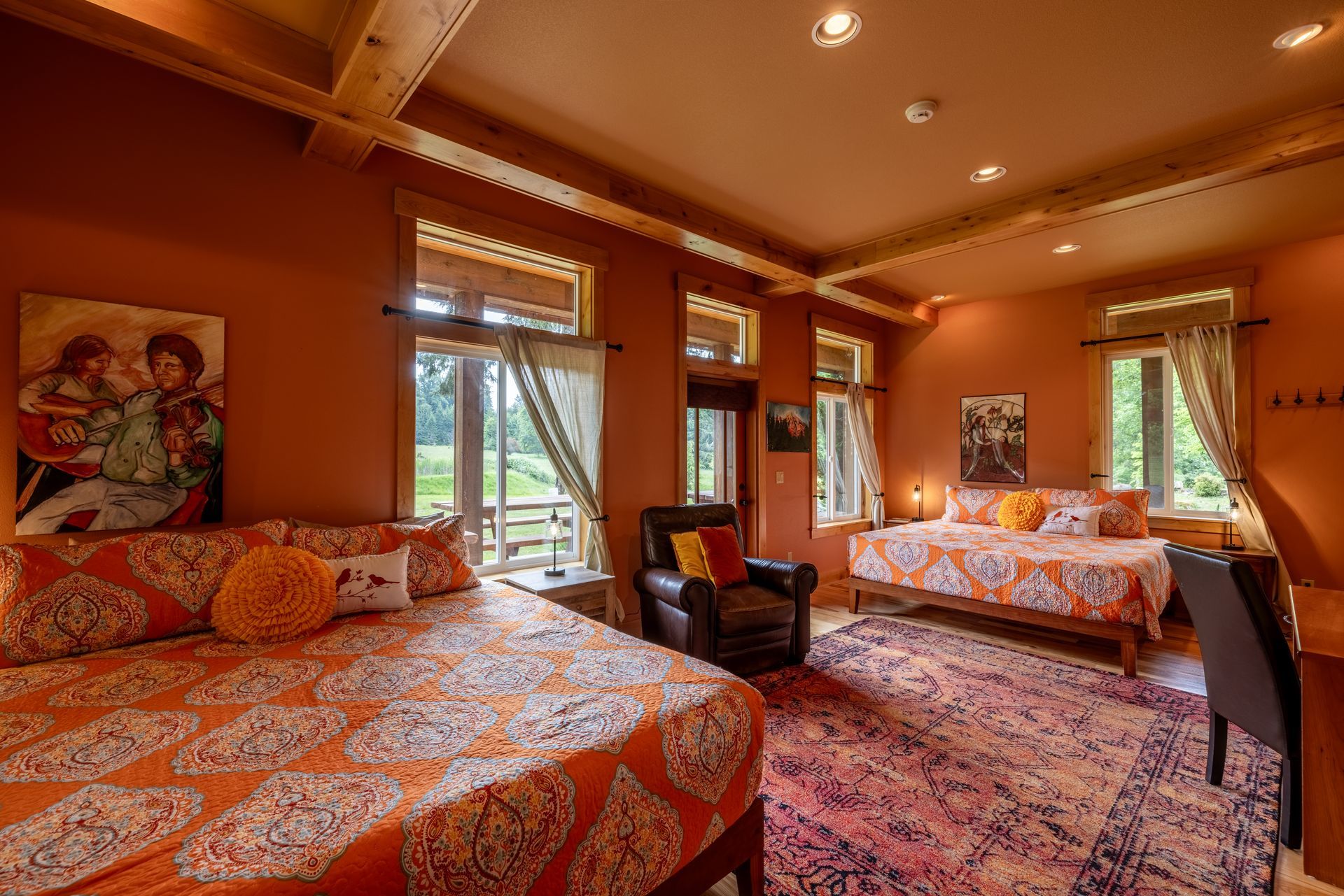 A bedroom with two beds a chair and a rug