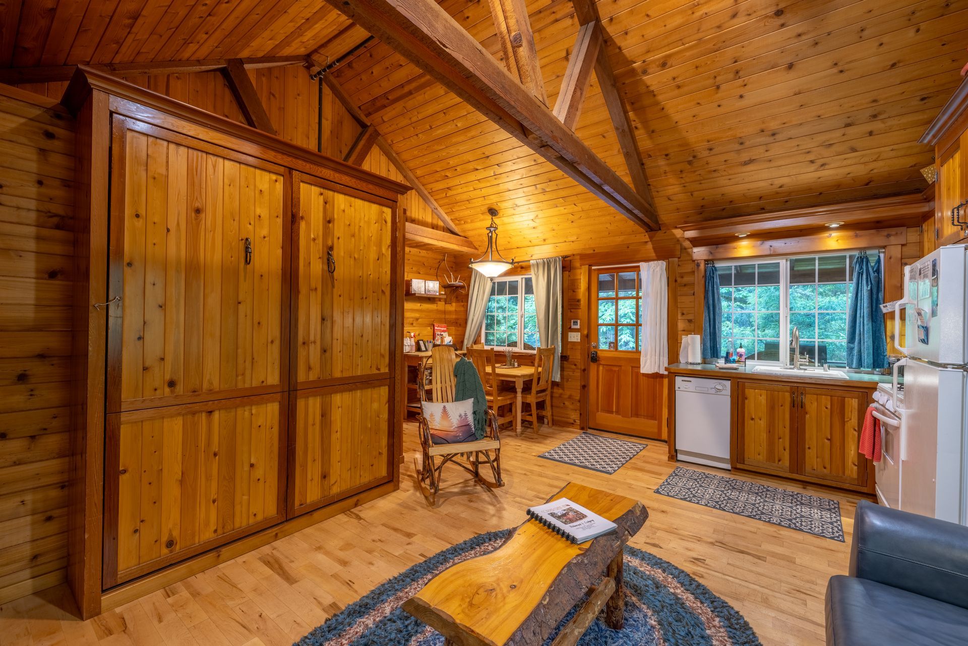 A wooden dining room with a table and chairs