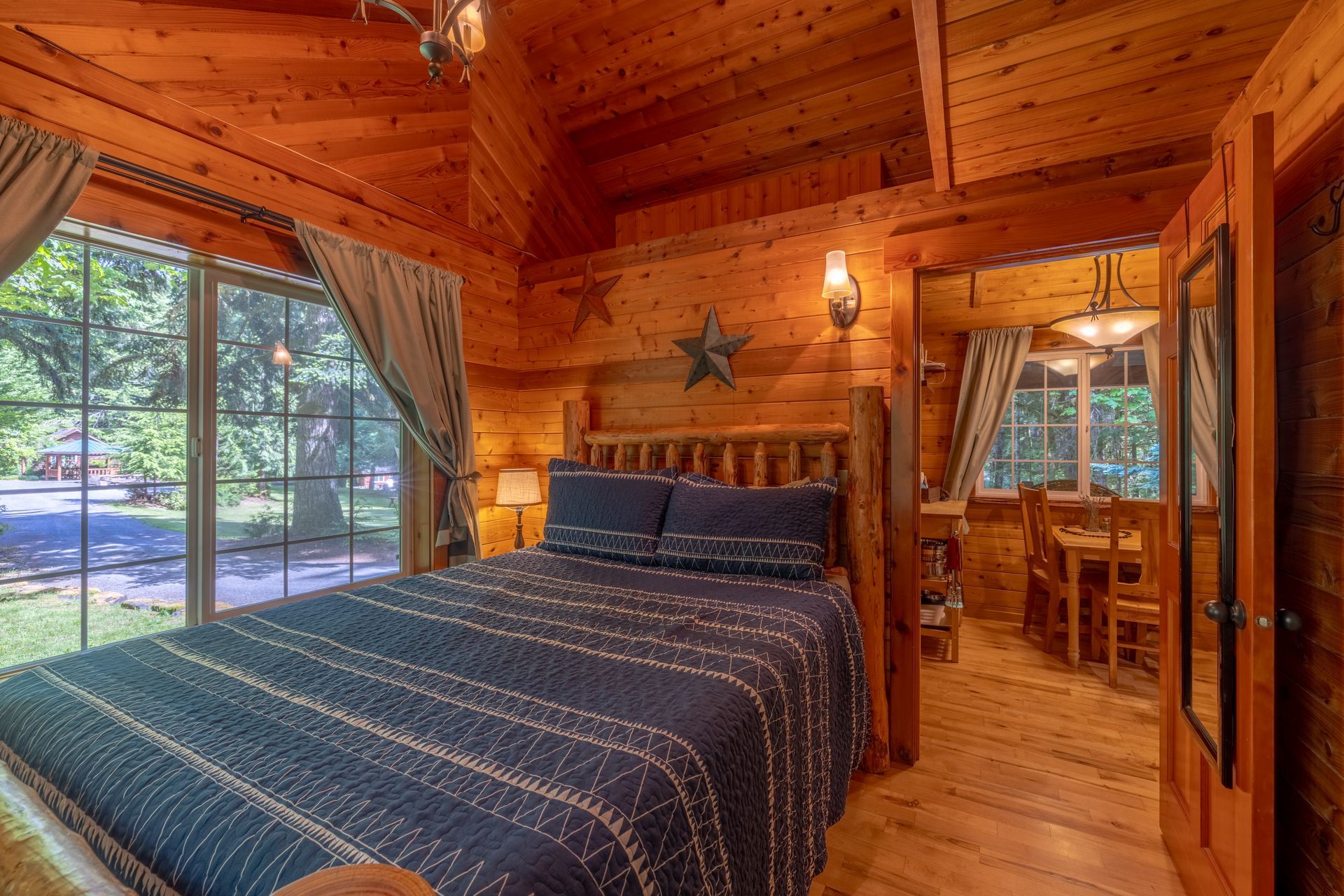 A log cabin bedroom with a bed and a window.