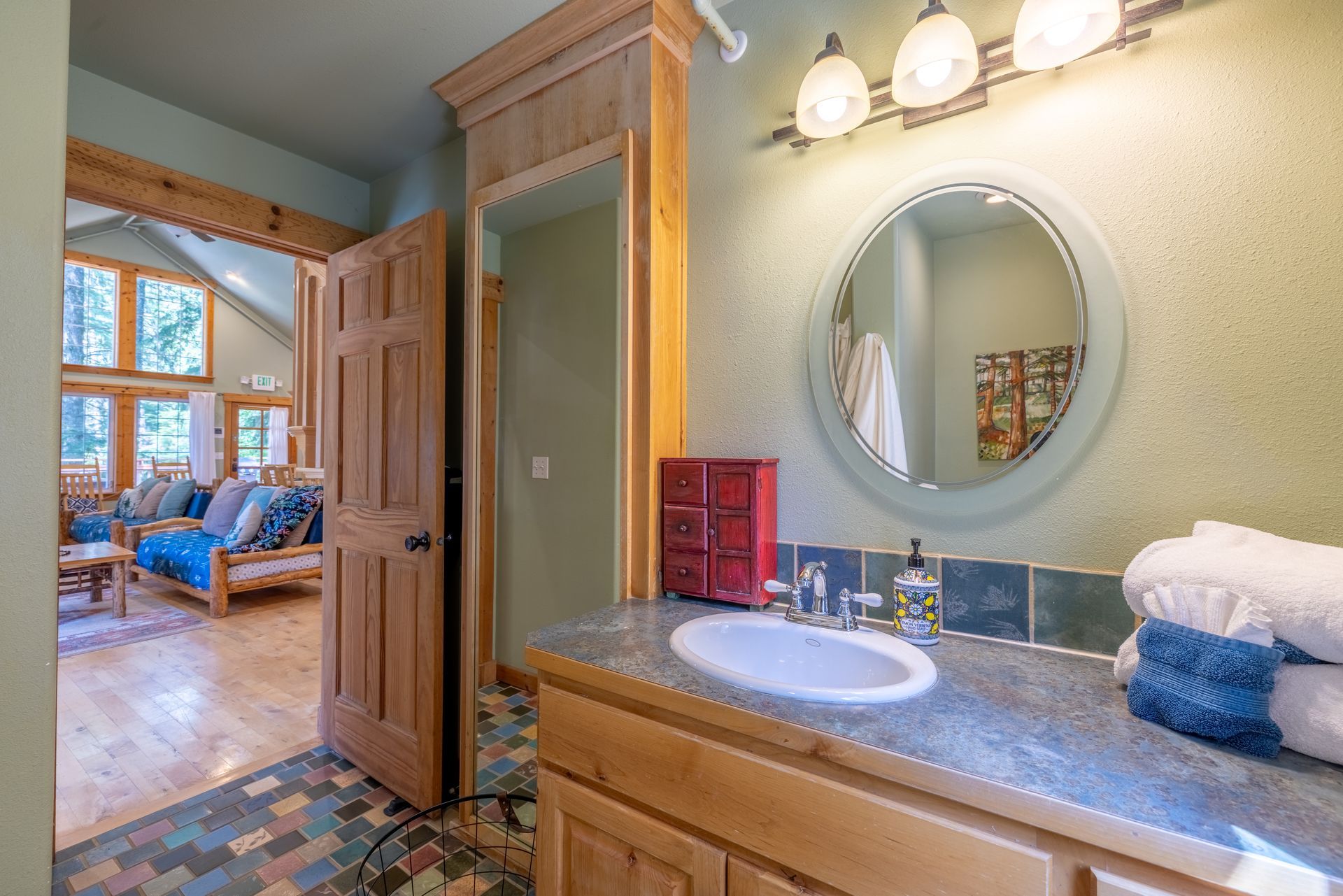 A bathroom with a sink a mirror and a window