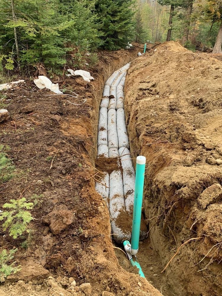 A white truck is parked in a parking lot next to a building.
