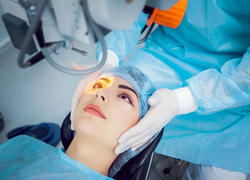 A woman is getting eye surgery in an operating room