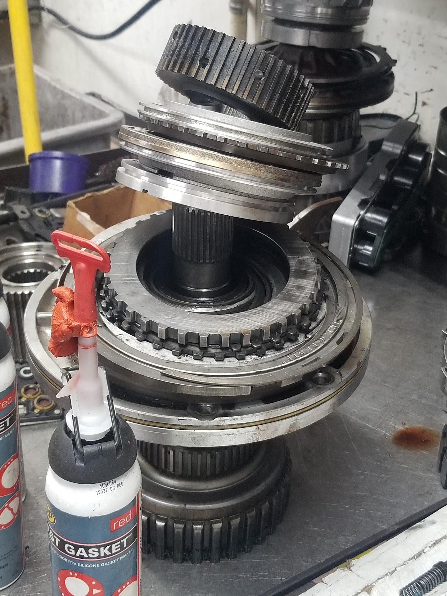 Disassembled car transmission components on a table | Riley Auto Care & Transmissions