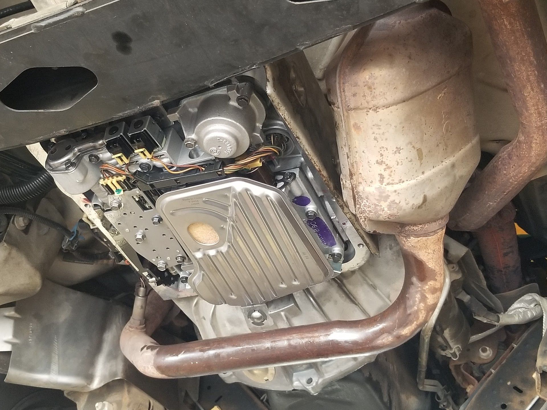 Undercarriage of a vehicle showing the exposed transmission pan | Riley Auto Care & Transmissions