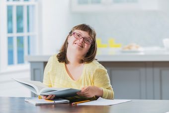 down syndrome girl with book