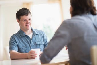 man with down syndrome talking to friend