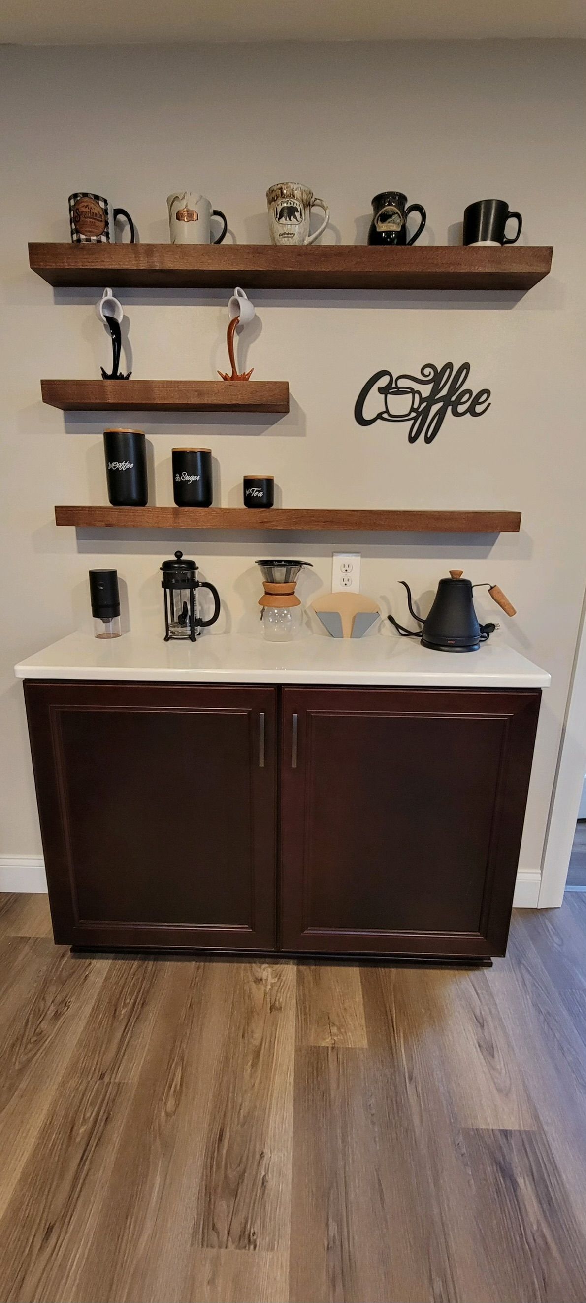 A coffee bar with shelves and a counter in a kitchen.