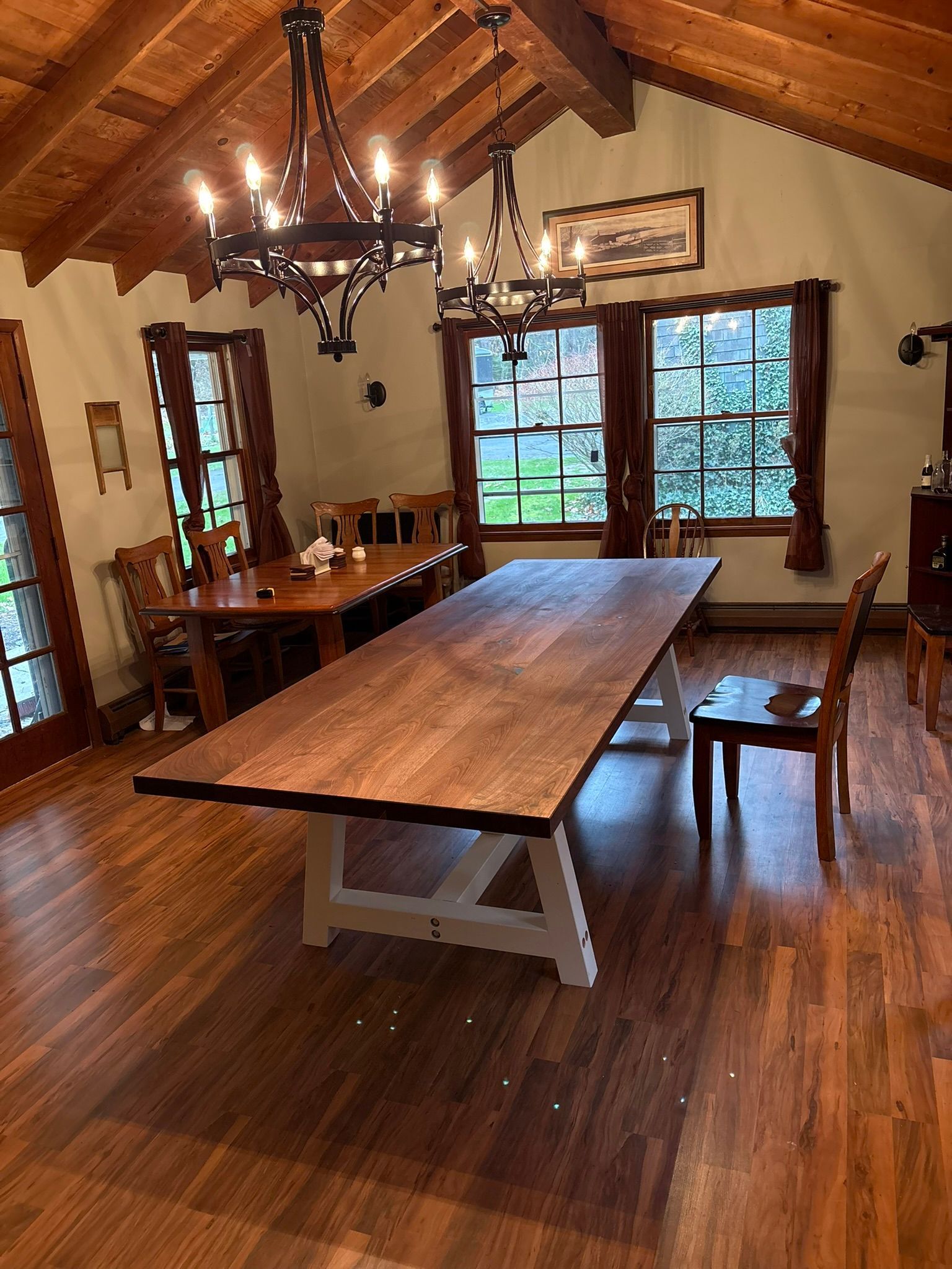 There is a long wooden table in the middle of the room.