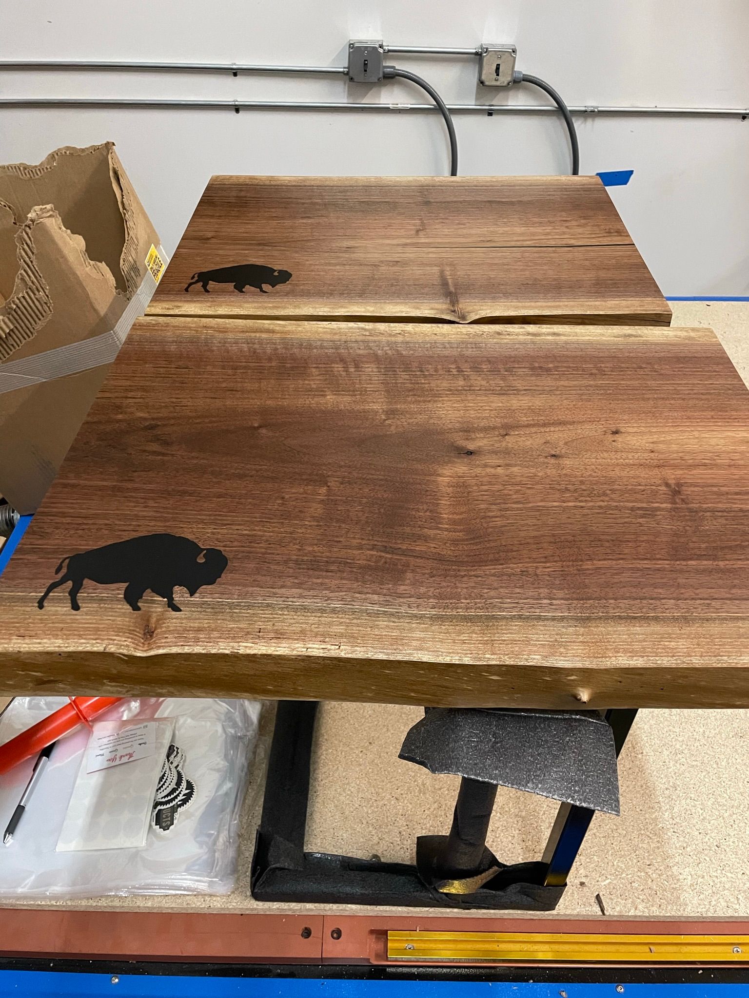 A wooden table with a silhouette of a bison on it.