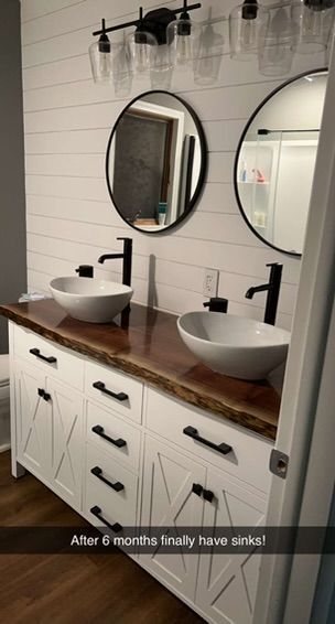 A bathroom with two sinks and two mirrors.