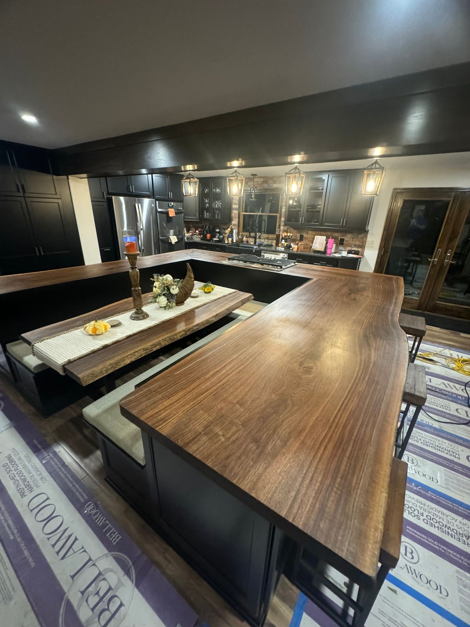 A kitchen with a large wooden table and benches.