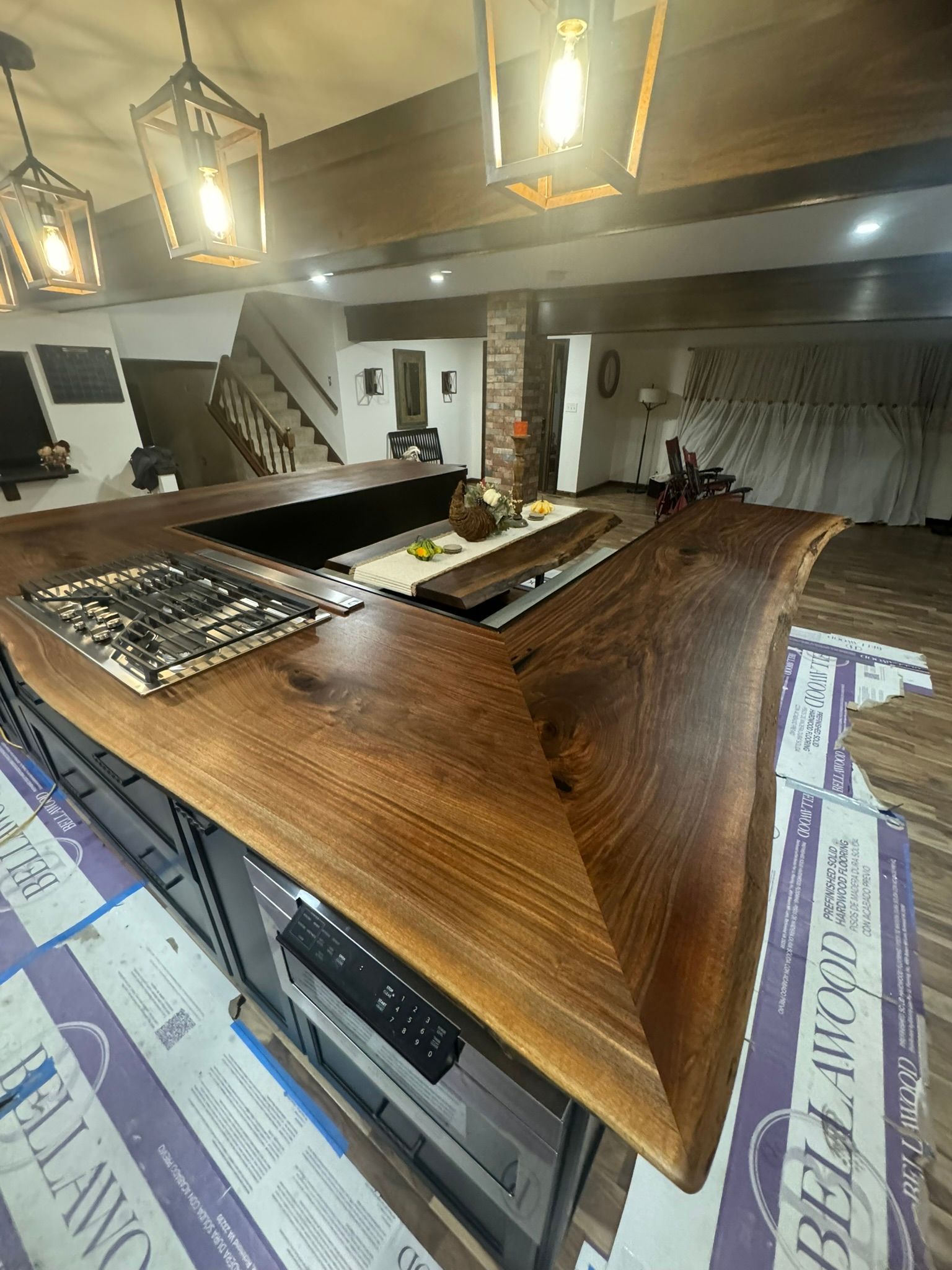 A kitchen with a wooden counter top and a stove top oven.