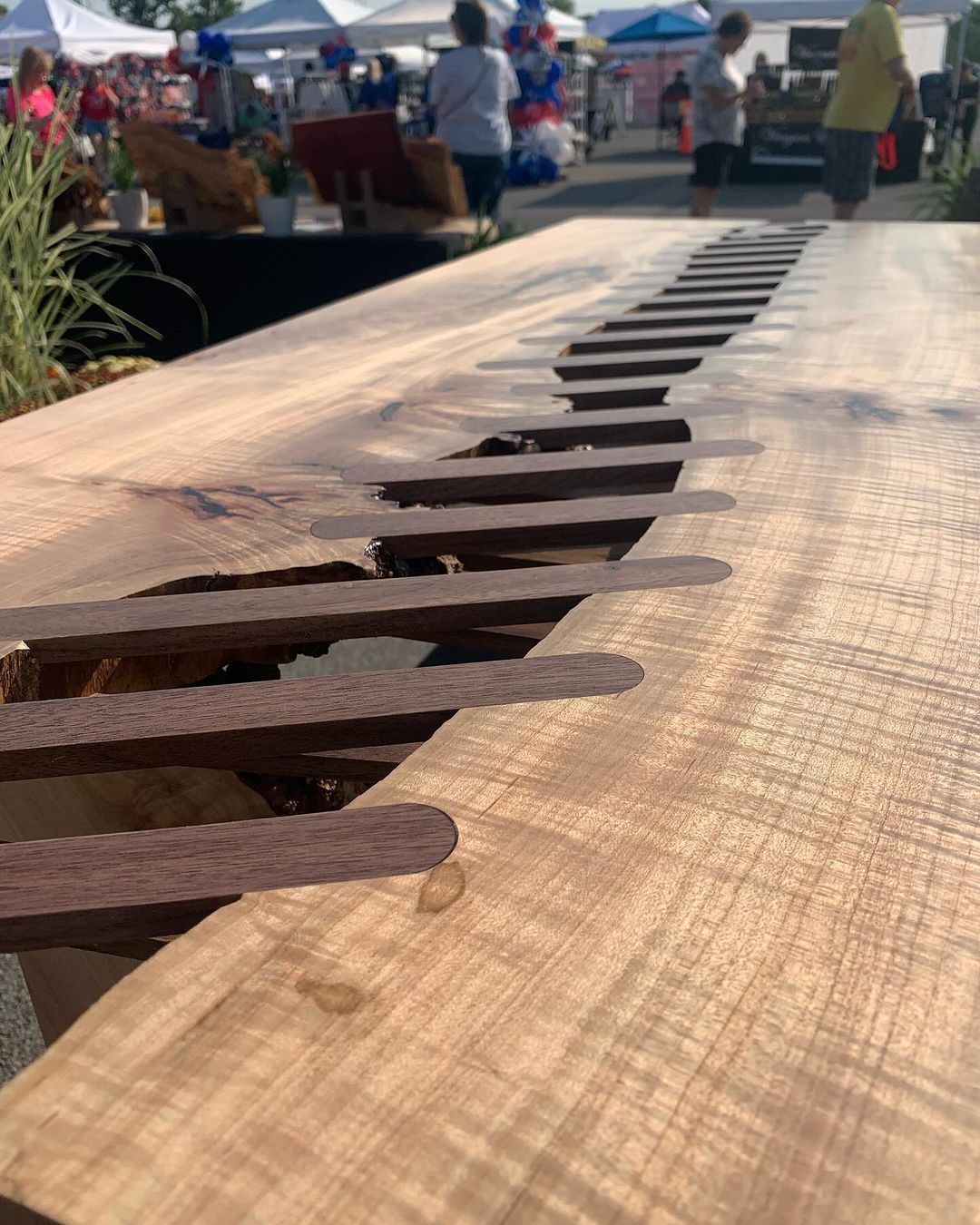 A close up of a wooden table with a metal grate on it.