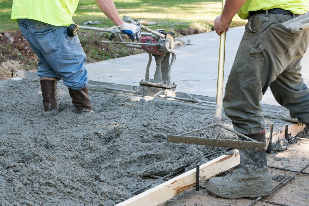 Two Construction Workers Smoothing Wet — Damon's Earthworks in Chatsworth, QLD