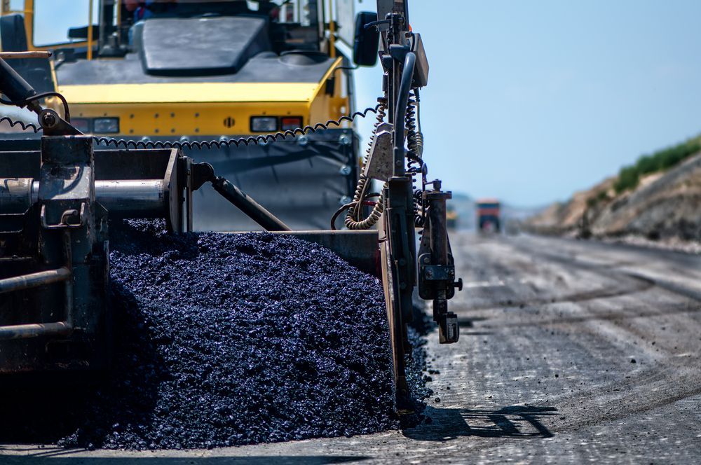 Asphalt Paving Machine Laying Asphalt on a Road — Damon's Earthworks in Chatsworth, QLD
