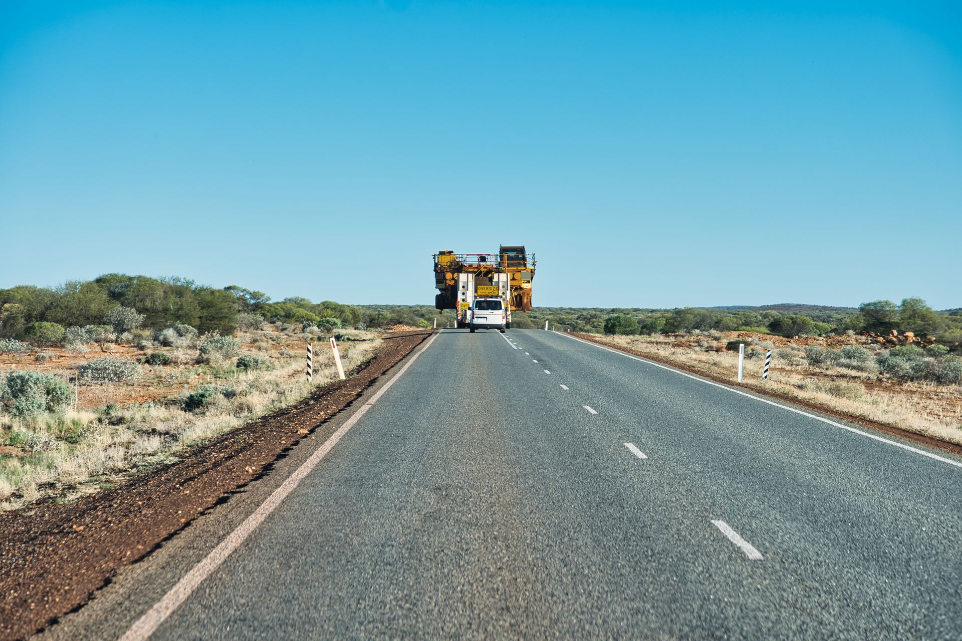 Road With a Massive Transport Vehicle Carrying Machinery — Damon's Earthworks in Chatsworth, QLD