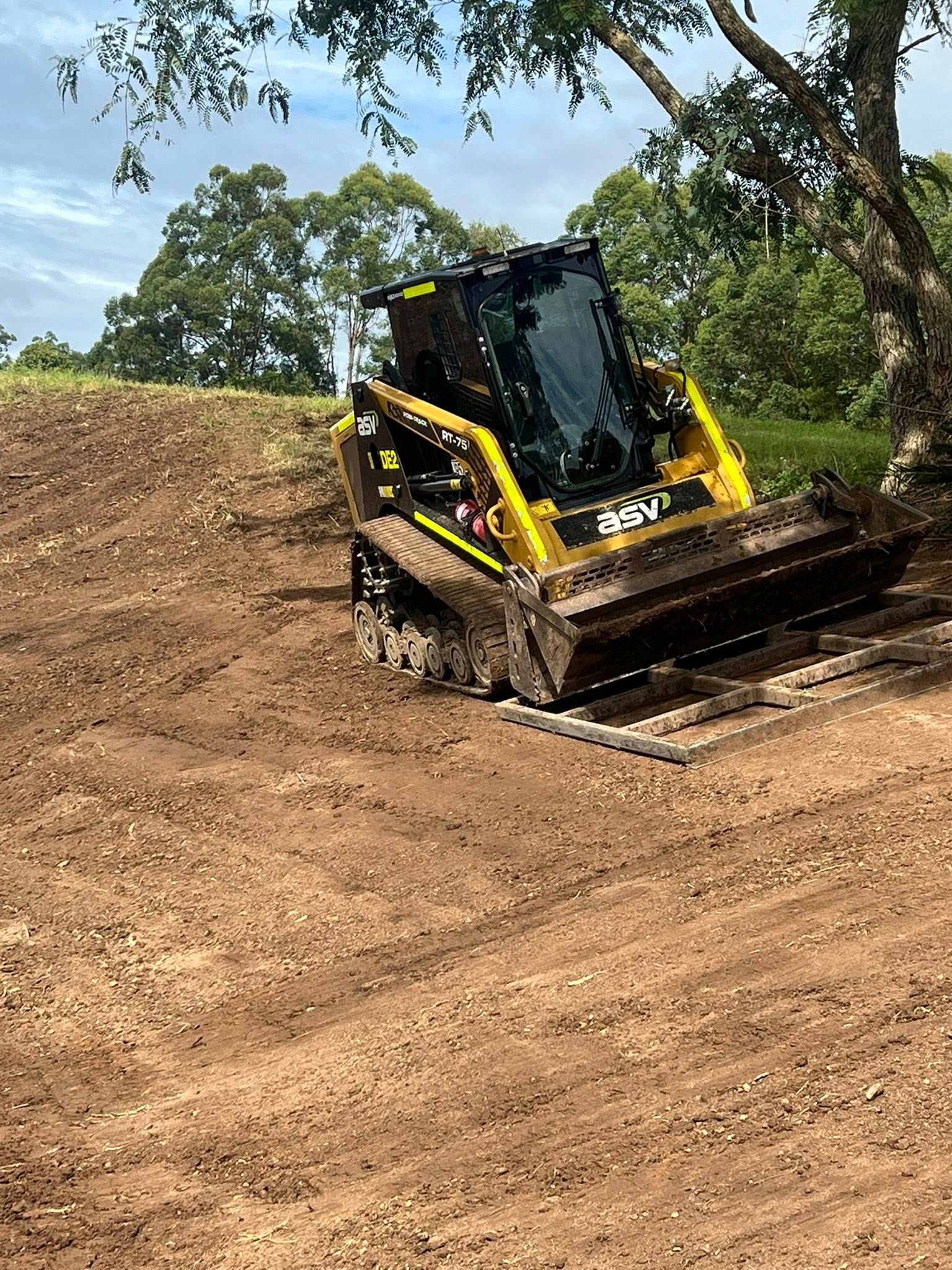 Yellow and Black Skid Steer on a Dirt Hill — Damon's Earthworks in Chatsworth, QLD