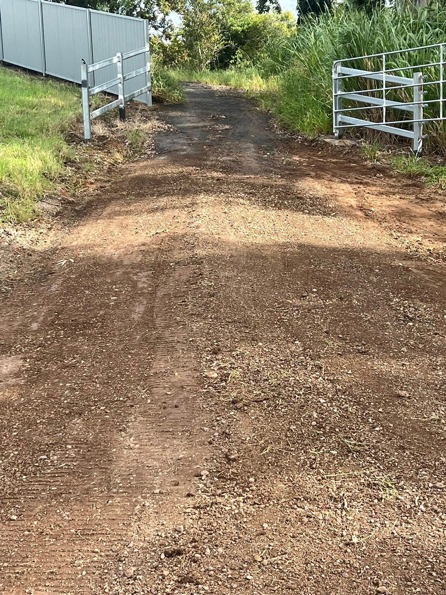 Man Pressure Washing a Concrete Driveway — Damon's Earthworks in Chatsworth, QLD