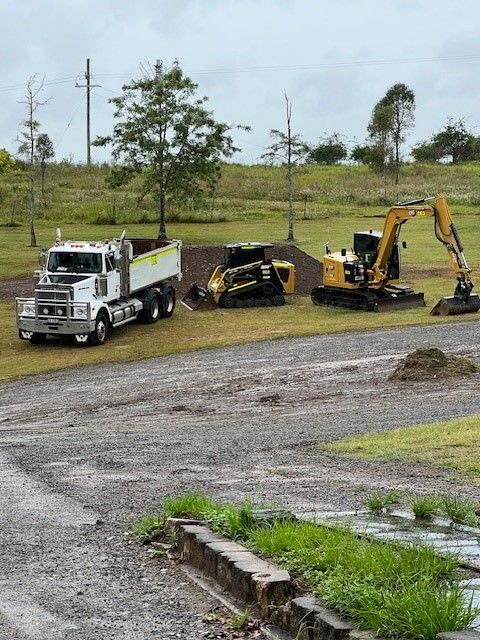 Two Workers Installing Solar Panels on a Sunny Day — Damon's Earthworks in Chatsworth, QLD