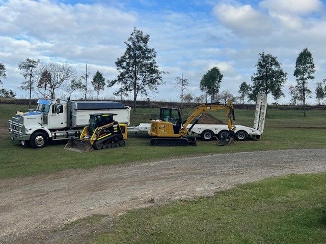 Yellow Excavator and Skid Steer on a Trailer — Damon's Earthworks in Chatsworth, QLD