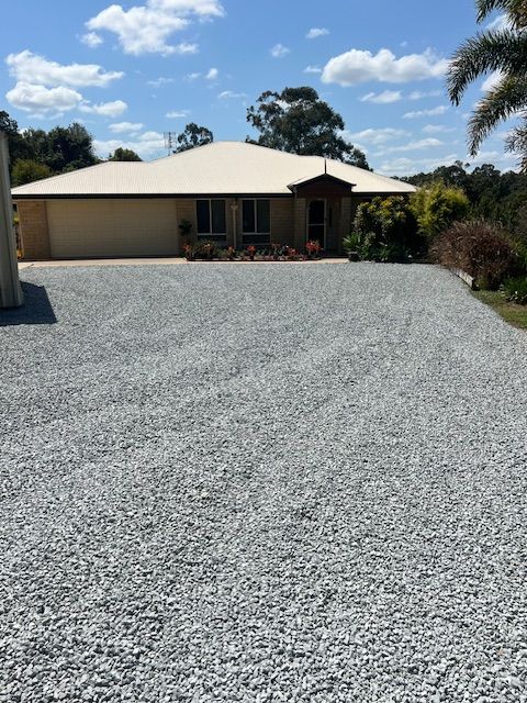 Person Power Washing a Brick Driveway — Damon's Earthworks in Chatsworth, QLD