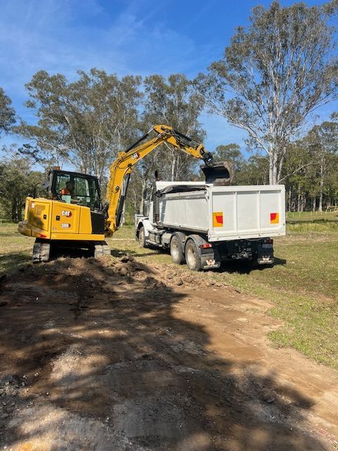 Yellow Bulldozer Removing Tree Roots — Damon's Earthworks in Chatsworth, QLD