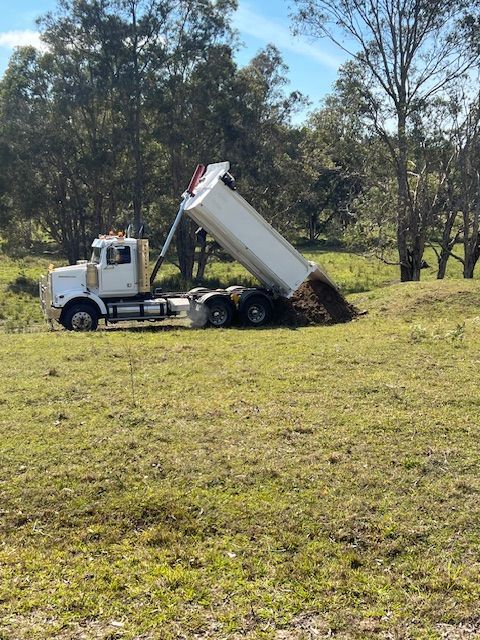 Dump Truck Unloading Sand on a Bright Day — Damon's Earthworks in Chatsworth, QLD