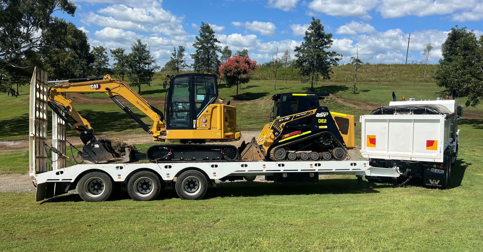 Green Tractor on a Flatbed Trailer — Damon's Earthworks in Chatsworth, QLD