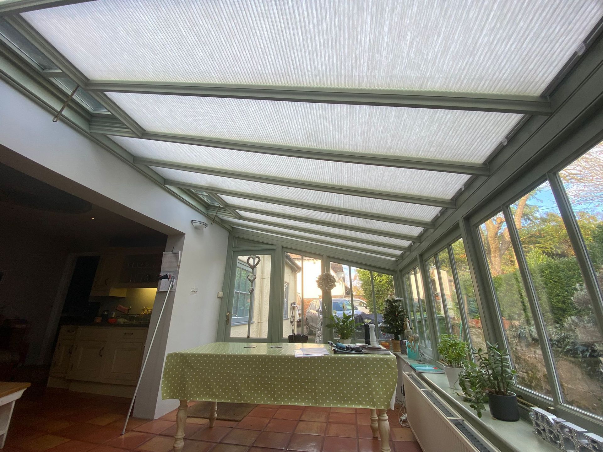 A conservatory with a table and a tablecloth in it.