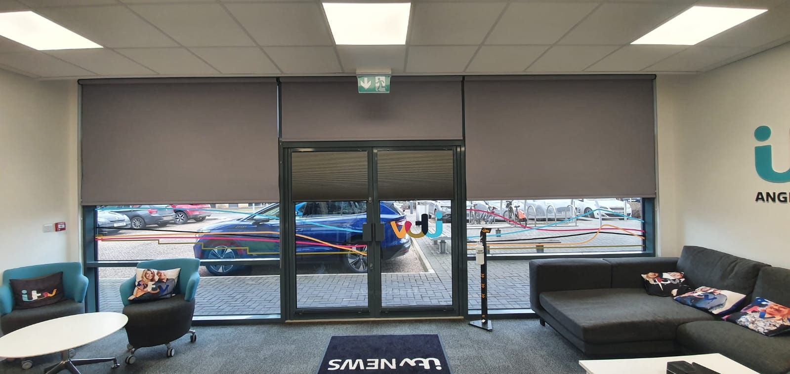 A living room with a couch , chairs , tables and blinds.