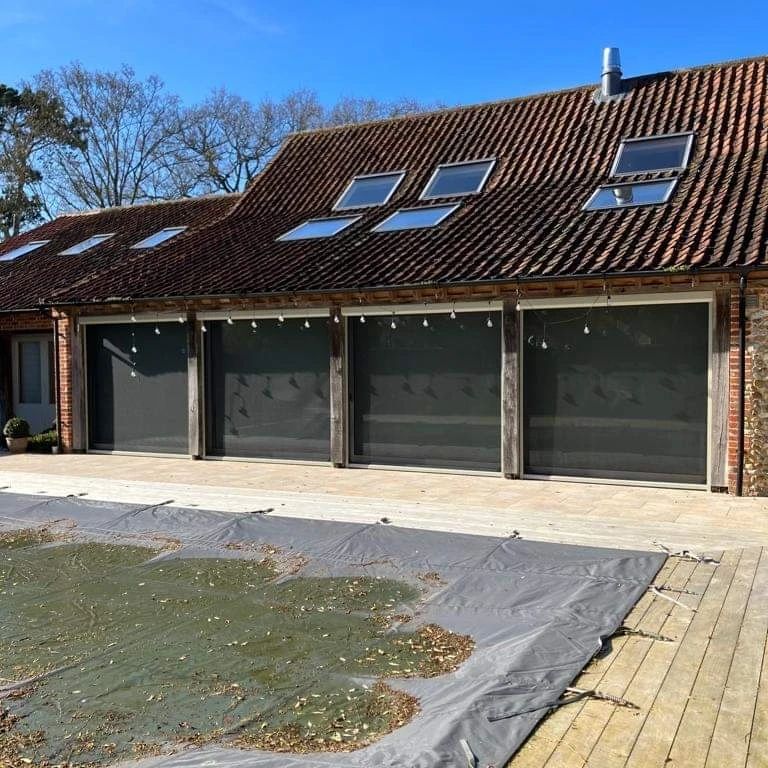 A large house with a swimming pool in front of it