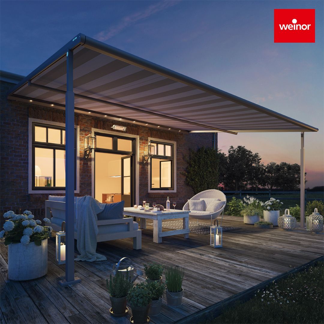 A house with a wooden deck and a canopy over it.