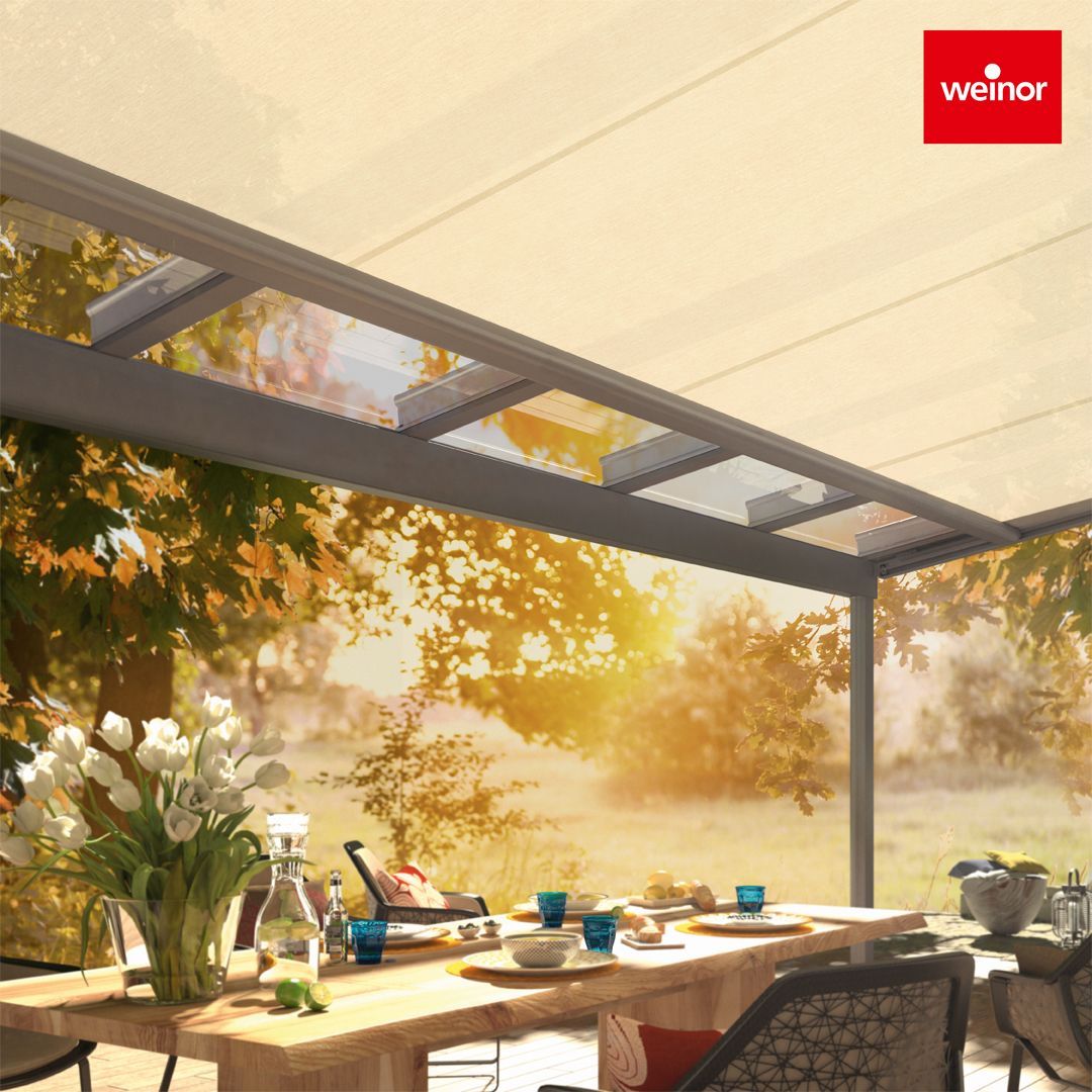 A table with a vase of flowers on it under a canopy