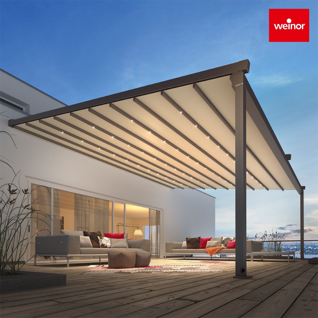 A patio with a pergola and a sign that says weinor