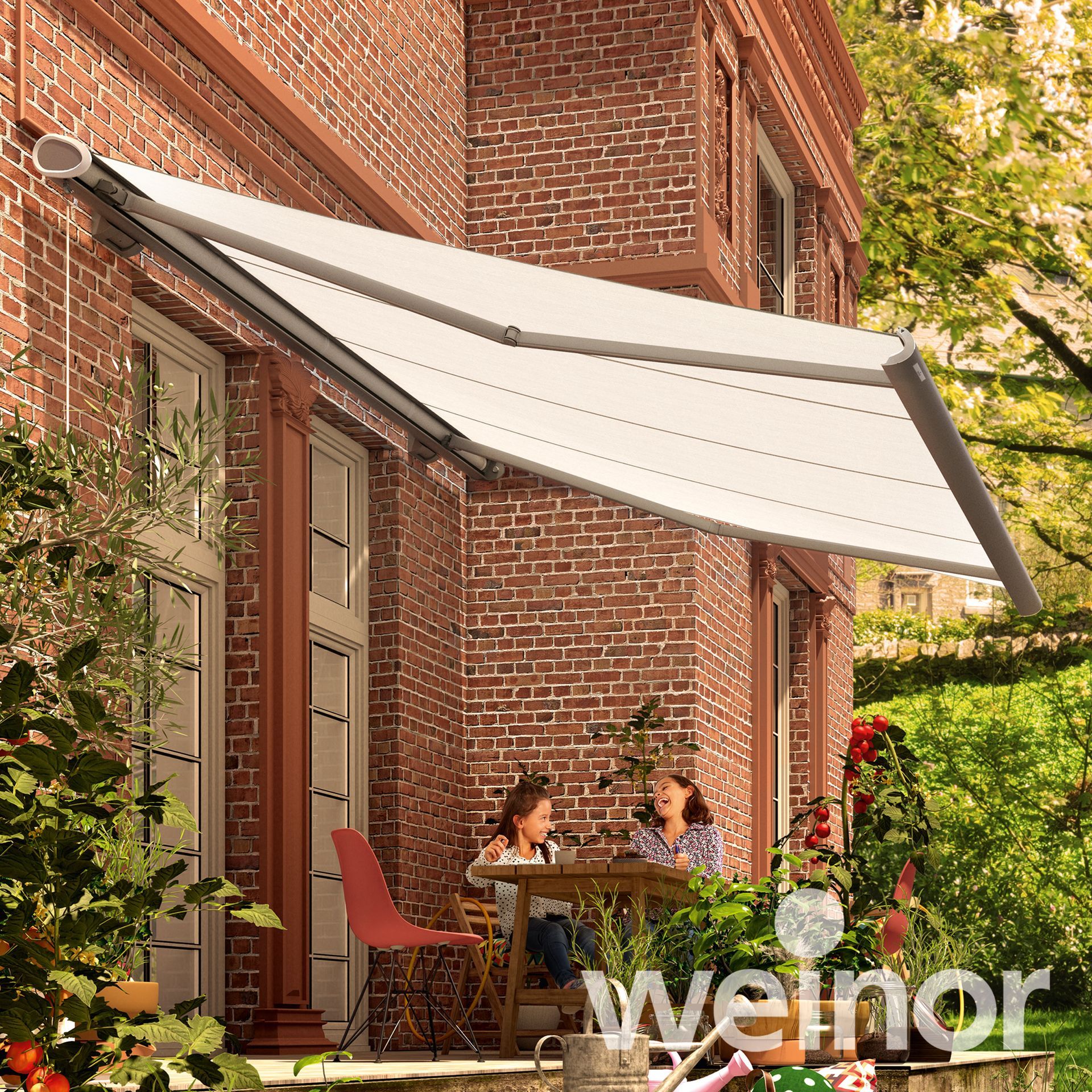 Two people sit at a table under an awning that says weinor