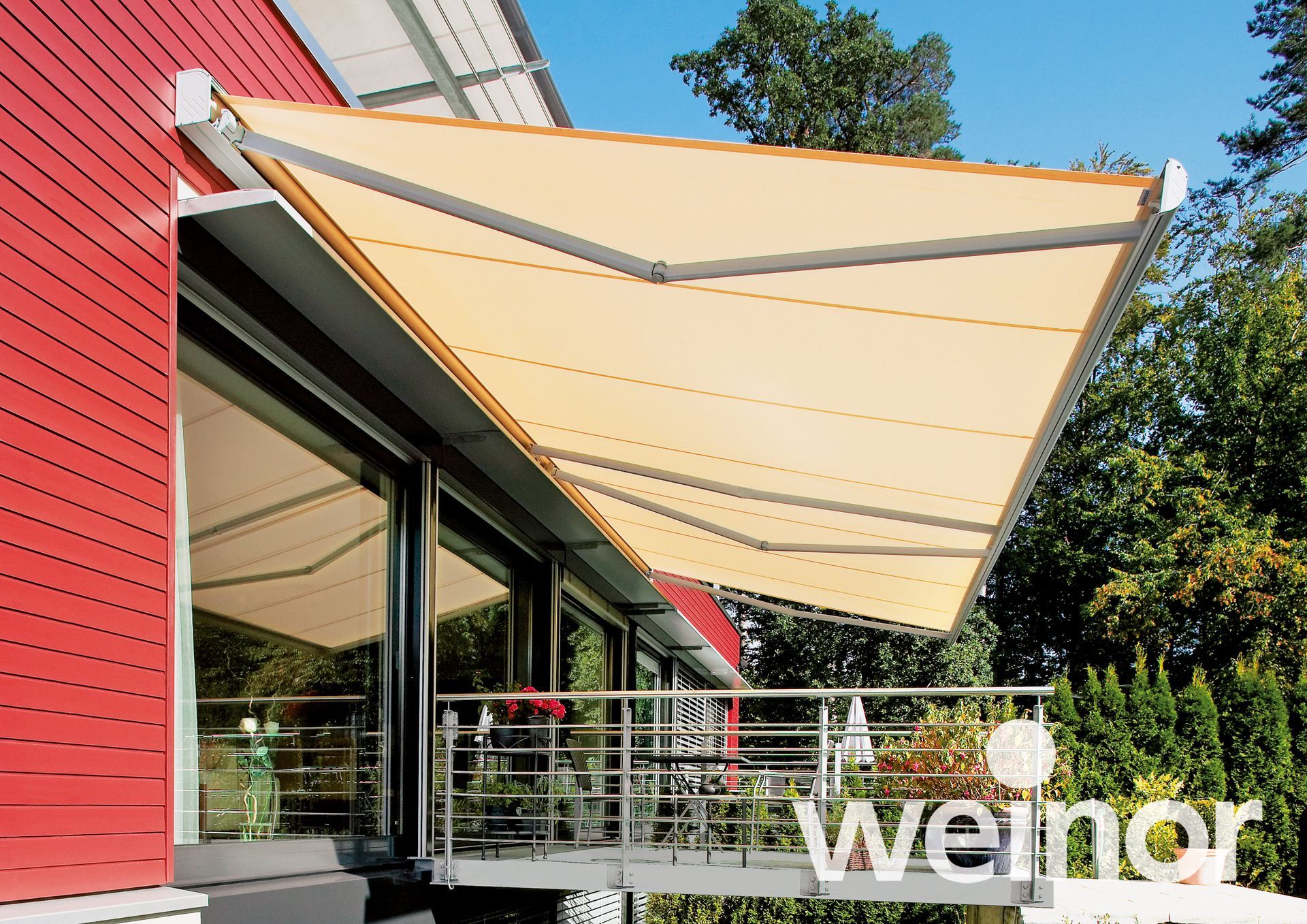 A large awning is on the side of a red building