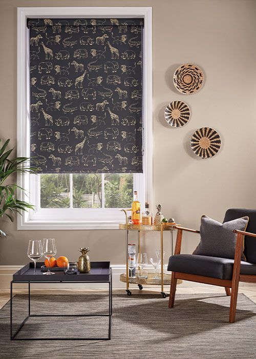 A living room with a chair , table , and window.