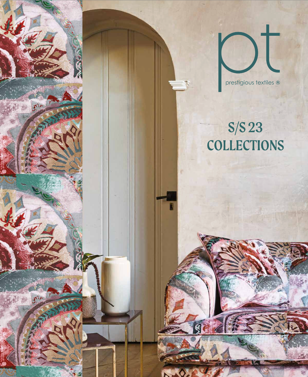 A living room with a couch and a vase on a table.