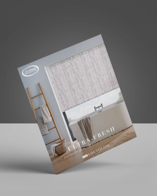 A brochure for ultra fresh shower curtains is sitting on a table.