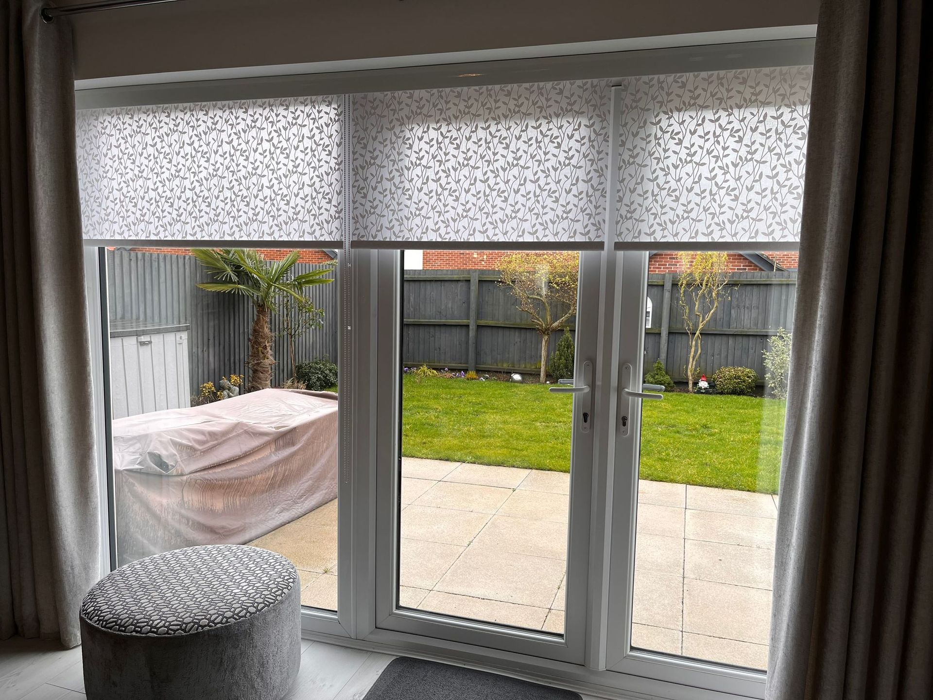 A living room with a sliding glass door leading to a patio.