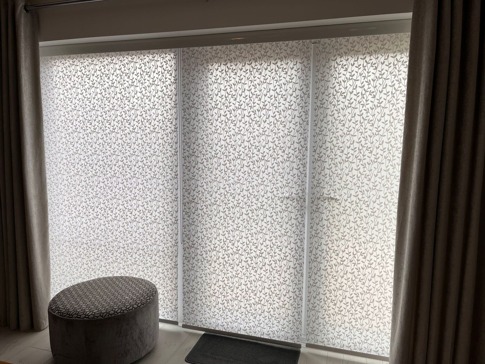 A sliding glass door with blinds on it in a living room.