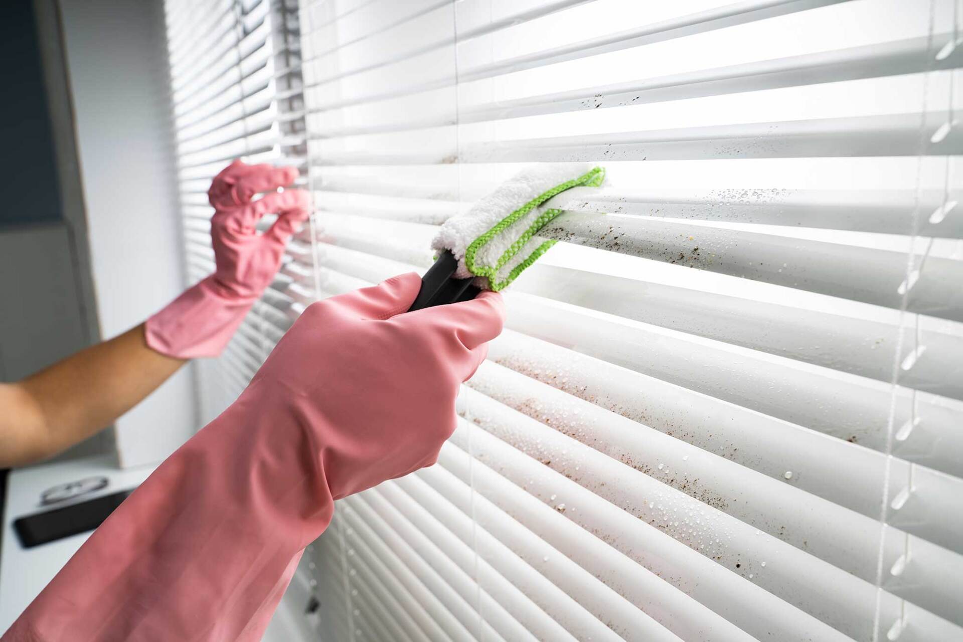 Person Cleaning Window Blinds — St. Louis, MO — Overland Shade Co.