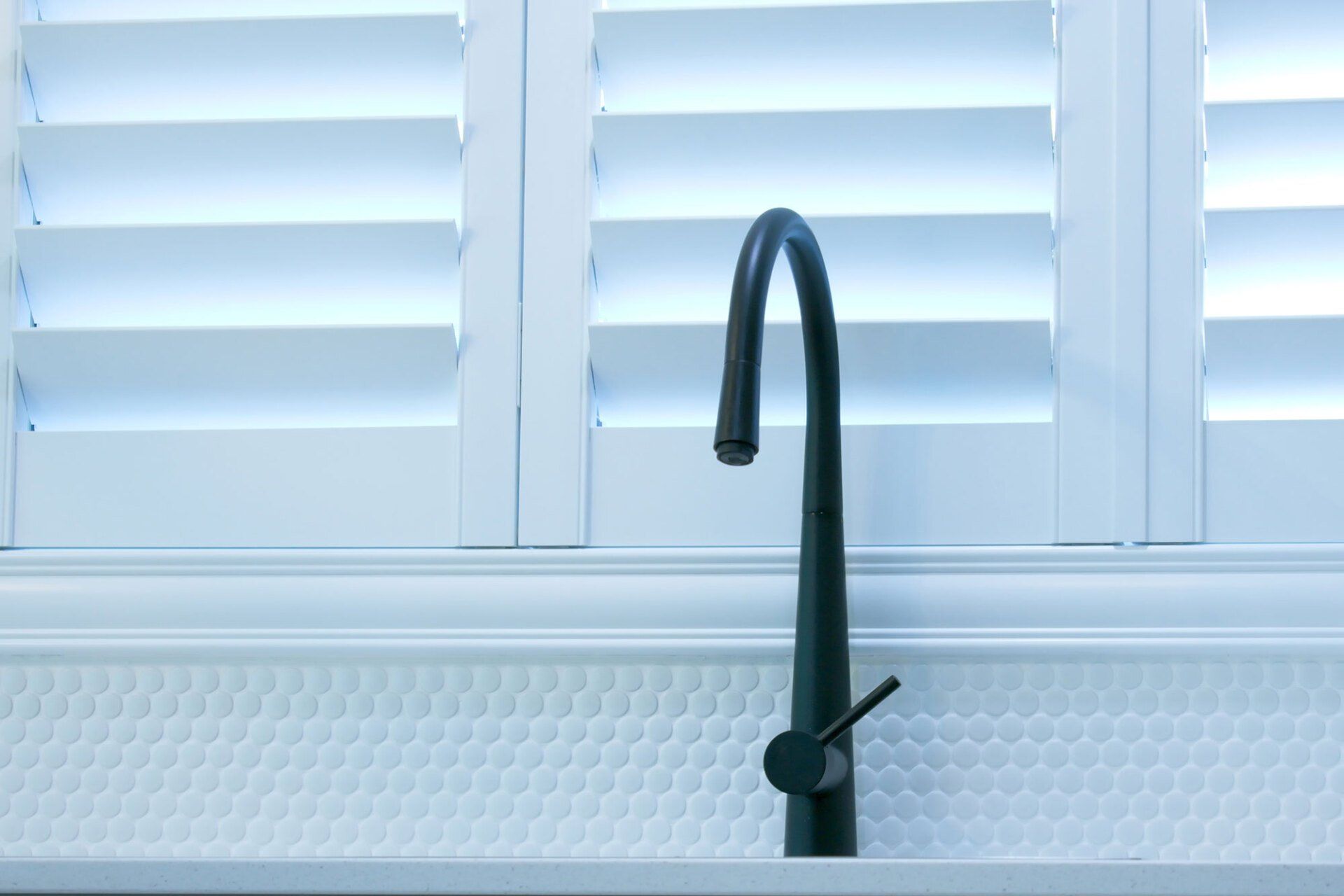 Kitchen with White Plantation Shutters and Black Mixer Tap — St. Louis, MO — Overland Shade Co.