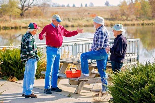 gentlemen fishing at pond located at the 55+ retirement community