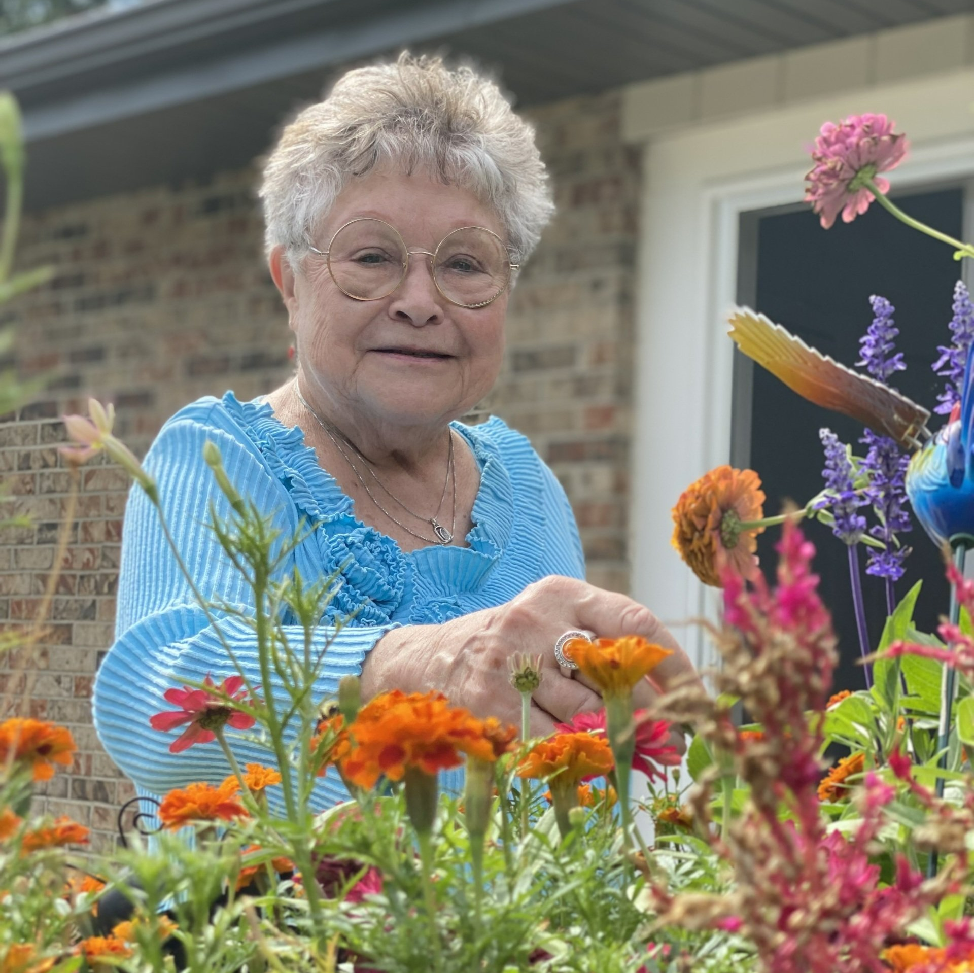 women living independently tending to her flowers at senior living community