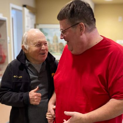 caregiver with resident walking in the hallway