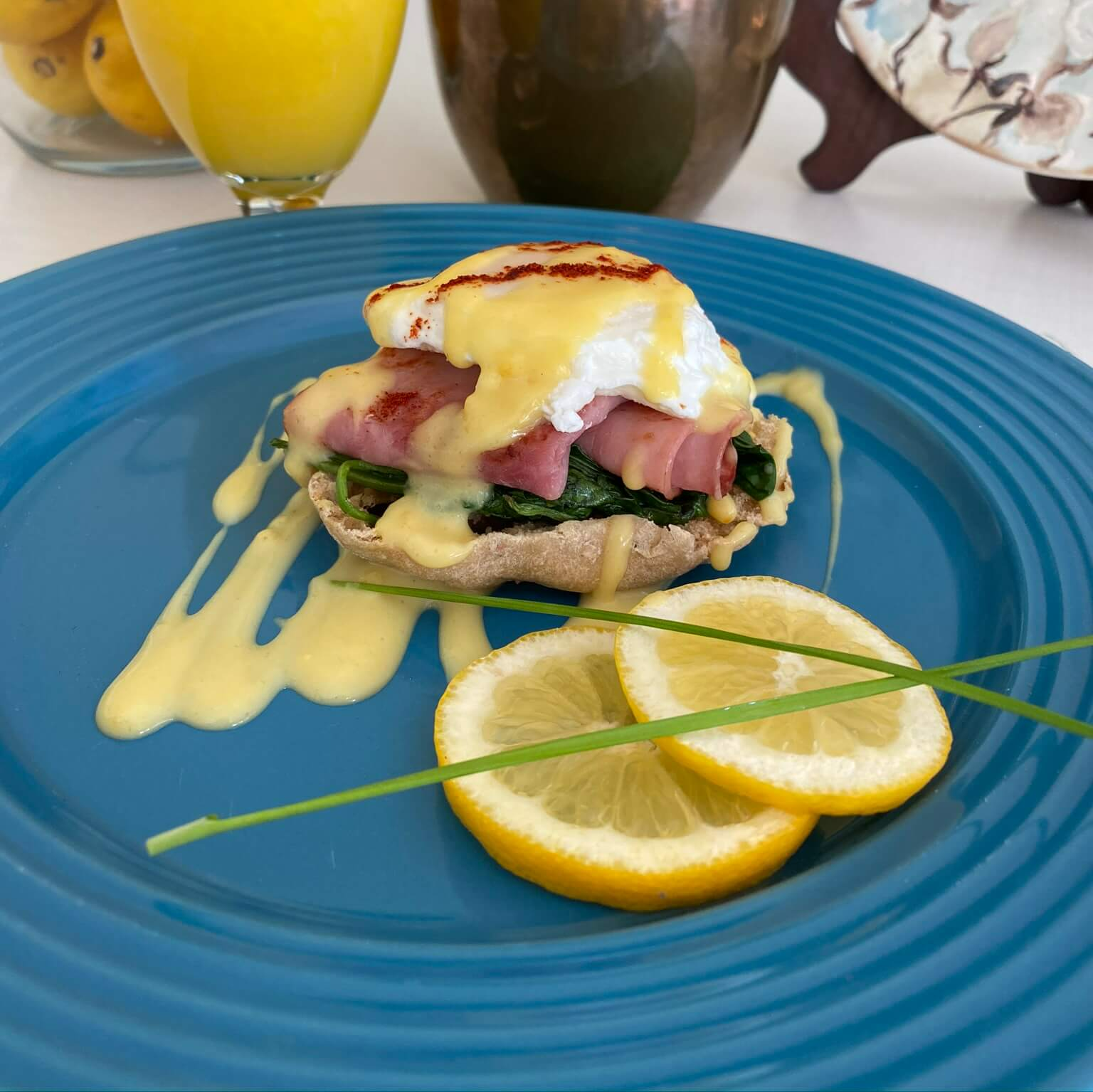 eggs benedict displayed on bright blue plate