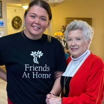Friends At Home employee standing with resident
