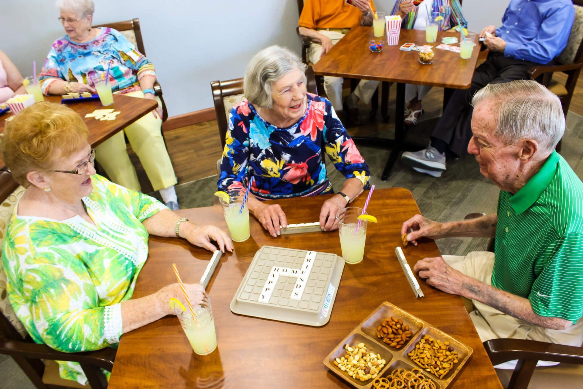 Active group of Friendship Village residents mingling and playing Scrabble in the Cove Lounge