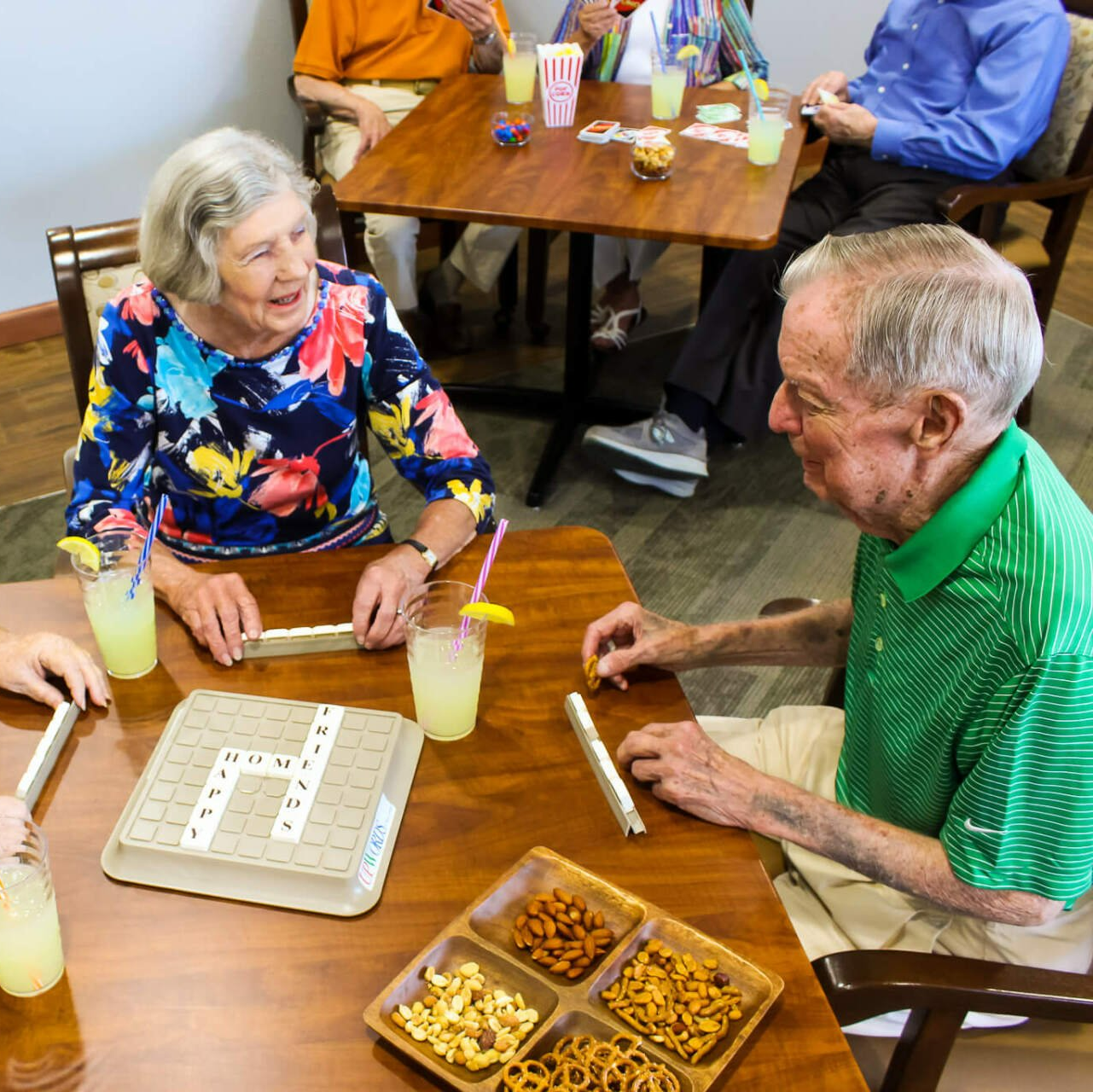 seniors actively playing Scrabble and eating snacks